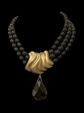 Vintage Three-Strand Black Beaded Necklace with Gold Sculpted Center